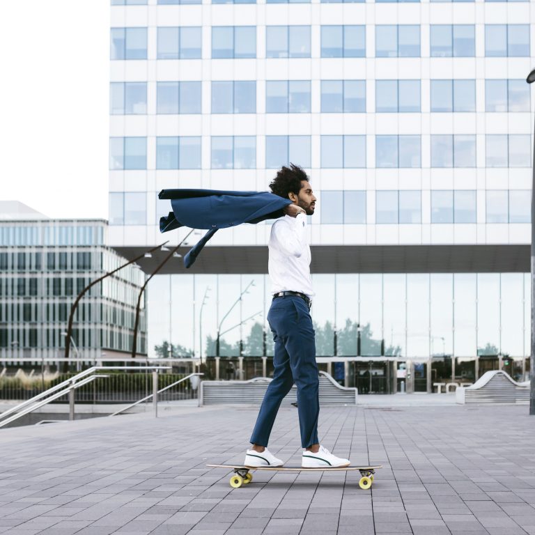 Spain, Barcelona, Young Businessman Riding Skateboard In The City Digitale Postlösung Arval